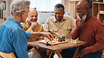 Chess, friends and board games on wooden table thinking of strategic or tactical move at home. Senior group of men playing and holding or moving white piece for attack in game of skill and tactics