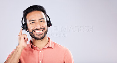 Buy stock photo Portrait, call center and mockup with a man customer service consultant in studio on a gray background. Contact us, crm or support and a male employee consulting with a headset on empty space