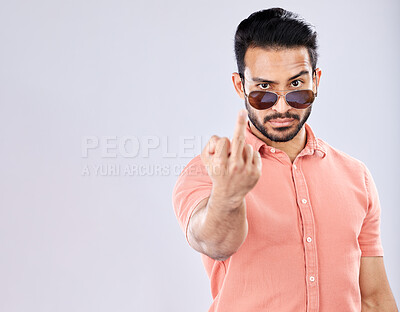 Buy stock photo Cool, rude and portrait of an Asian man with a middle finger isolated on a grey studio background. Mockup, angry and mean guy with an offensive hand gesture, expression and space on a backdrop