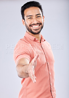 Buy stock photo Smile, handshake and portrait of a business man in isolated, gray background in studio. Shaking hands, agreement and yes hand gesture of a young man with happiness and thank you hands sign for deal