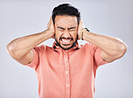 Loud, mental health and angry Asian man with schizophrenia isolated on a grey studio background. Stress, fear and scared guy closing ears for noise, scared and bipolar pressure on a backdrop