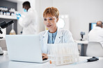Science, healthcare and scientist with a laptop for research, innovation and pharmaceutical email.  Lab, pharmacy and mature woman reading results of virus on a computer for analysis and breakthrough