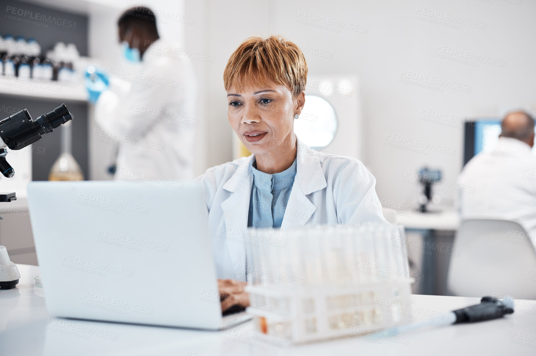 Buy stock photo Science, healthcare and scientist with a laptop for research, innovation and pharmaceutical email.  Lab, pharmacy and mature woman reading results of virus on a computer for analysis and breakthrough