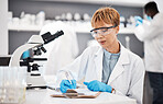 Scientist, woman and writing lab report with results, focus or analysis for pharma development. Science expert, checklist and documents with microscope, innovation and results of pharmaceutical trial