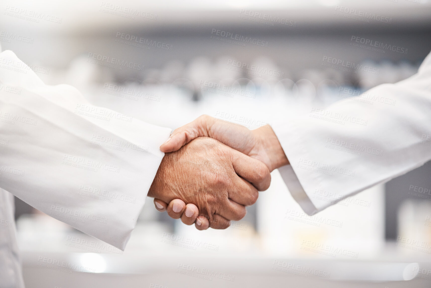 Buy stock photo Closeup, handshake and doctors with collaboration, research and partnership for healthcare. Zoom, hand and scientists with agreements, teamwork for wellness or update for data analytics in laboratory