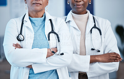 Buy stock photo Closeup, doctors and women arms crossed, leadership and confident in hospital, serious and healthcare. Zoom, female employees and medical professional with skills, clinic and teamwork for motivation