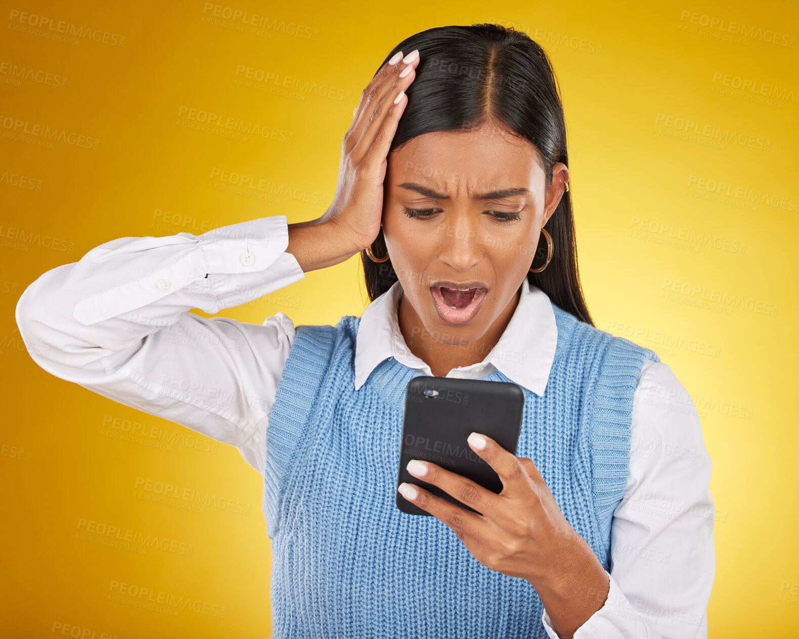 Buy stock photo News, shock and notification with Indian woman and phone for social media, gossip and update. Scam, worry and fraud with girl and post for error, technology and internet in yellow background studio 