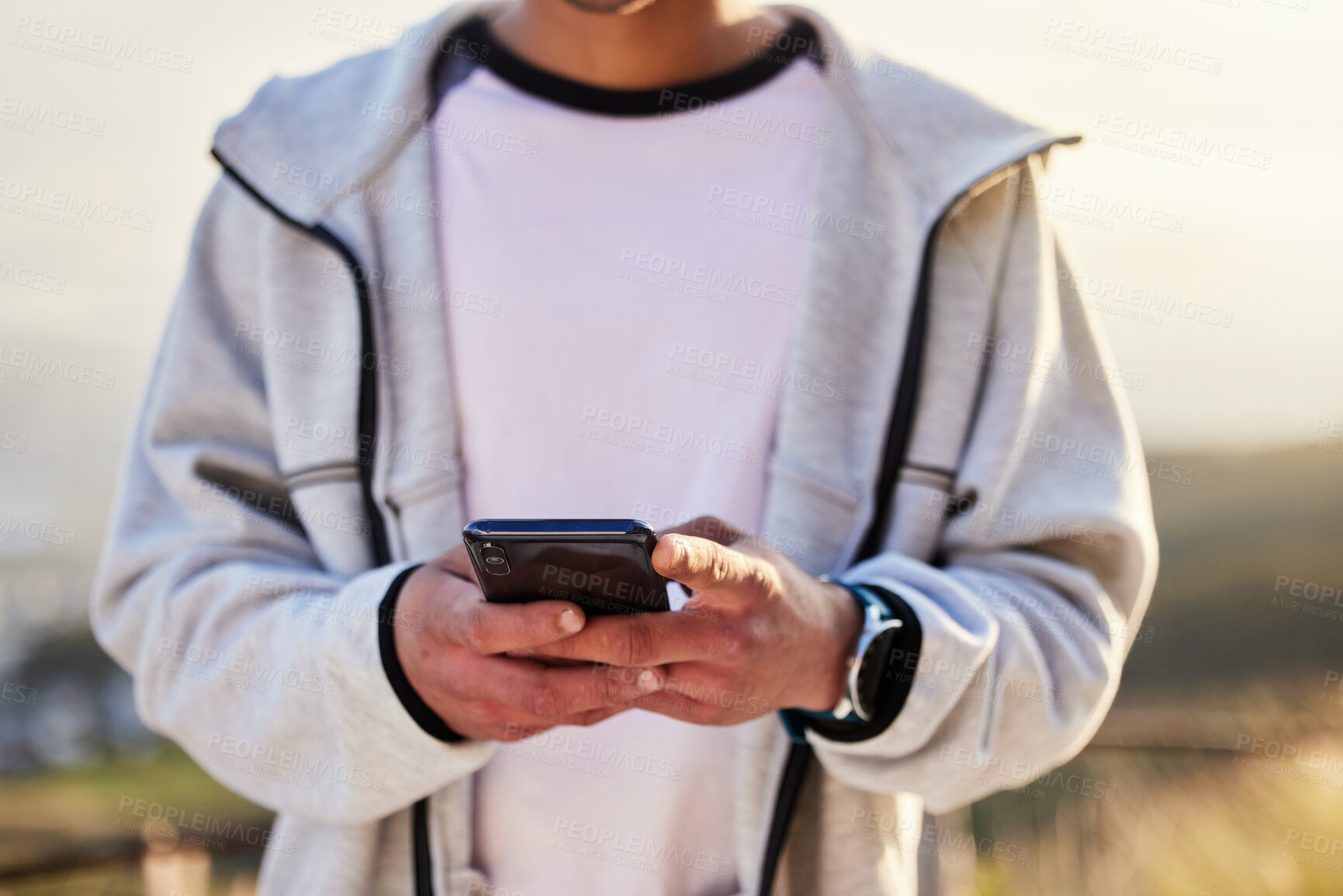 Buy stock photo Fitness man, hands and phone in social media, chatting or texting for travel, journey or trip in the nature outdoors. Hand of male typing on smartphone with 5G connection for GPS in the countryside