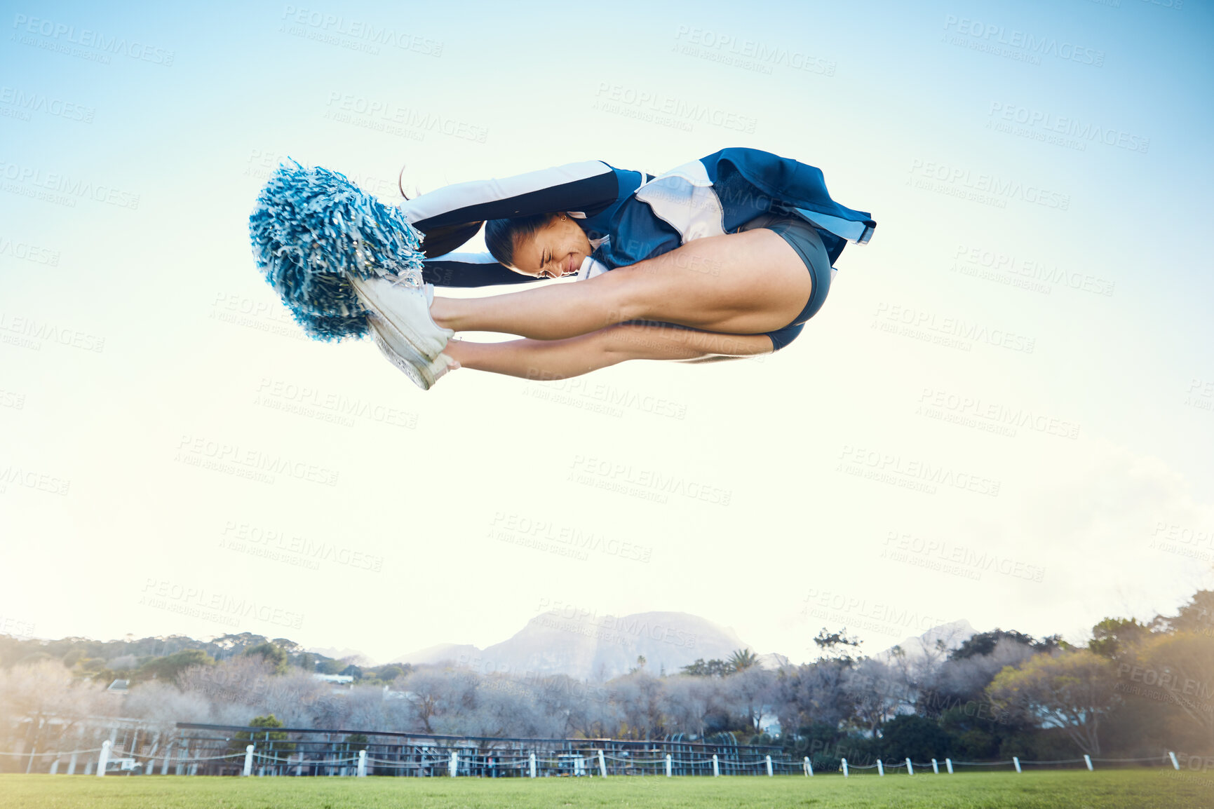 Buy stock photo Cheerleader woman, jump and sports outdoor on blue sky for performance, energy and celebration. Cheerleading person dance or stunt for training workout, freedom or competition to support game
