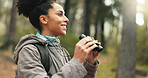 Hiking, forest and woman with binocular watch nature scenery, view or bird watching while trekking through trees. Adventure woods, travel journey or Brazil black girl backpacking in Amazon Rainforest