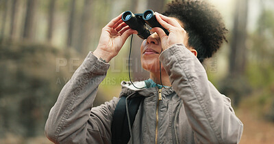 Hiking, forest and woman with binocular watch nature scenery, view or bird watching while trekking through trees. Adventure woods, travel journey or Brazil black girl backpacking in Amazon Rainforest