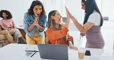 Success, fist bump or happy employees with a handshake in celebration of digital marketing sales goals at office desk. Laptop, winner or excited women celebrate winning an online business deal at job Success, fist bump or happy employees with a handshake
