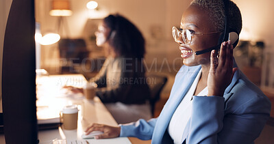 Call center, customer service and night shift black woman telemarketing consultant wearing headset at computer. Sales female in contact us and crm support talking during call working late with smile