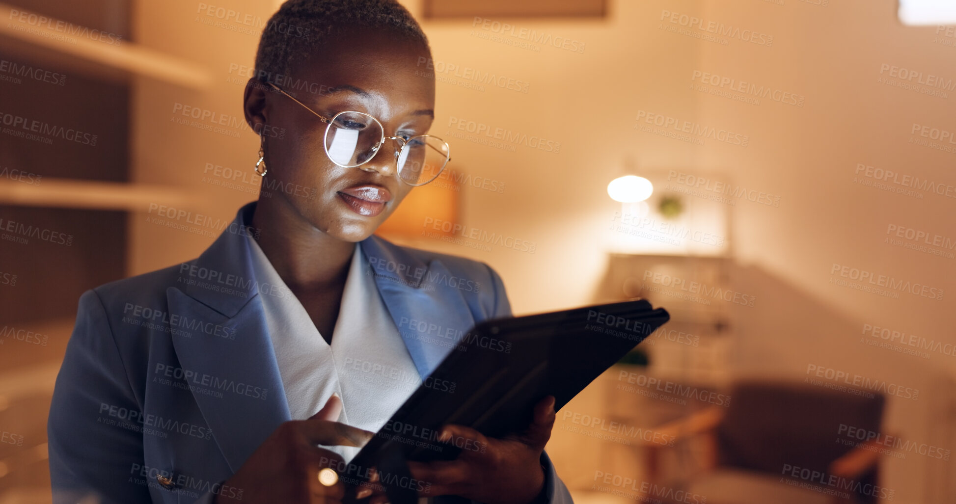 Buy stock photo Black woman, tablet and planning at night in office working on digital design project or online research. Social media, internet scroll and employee with company website on tech of web designer