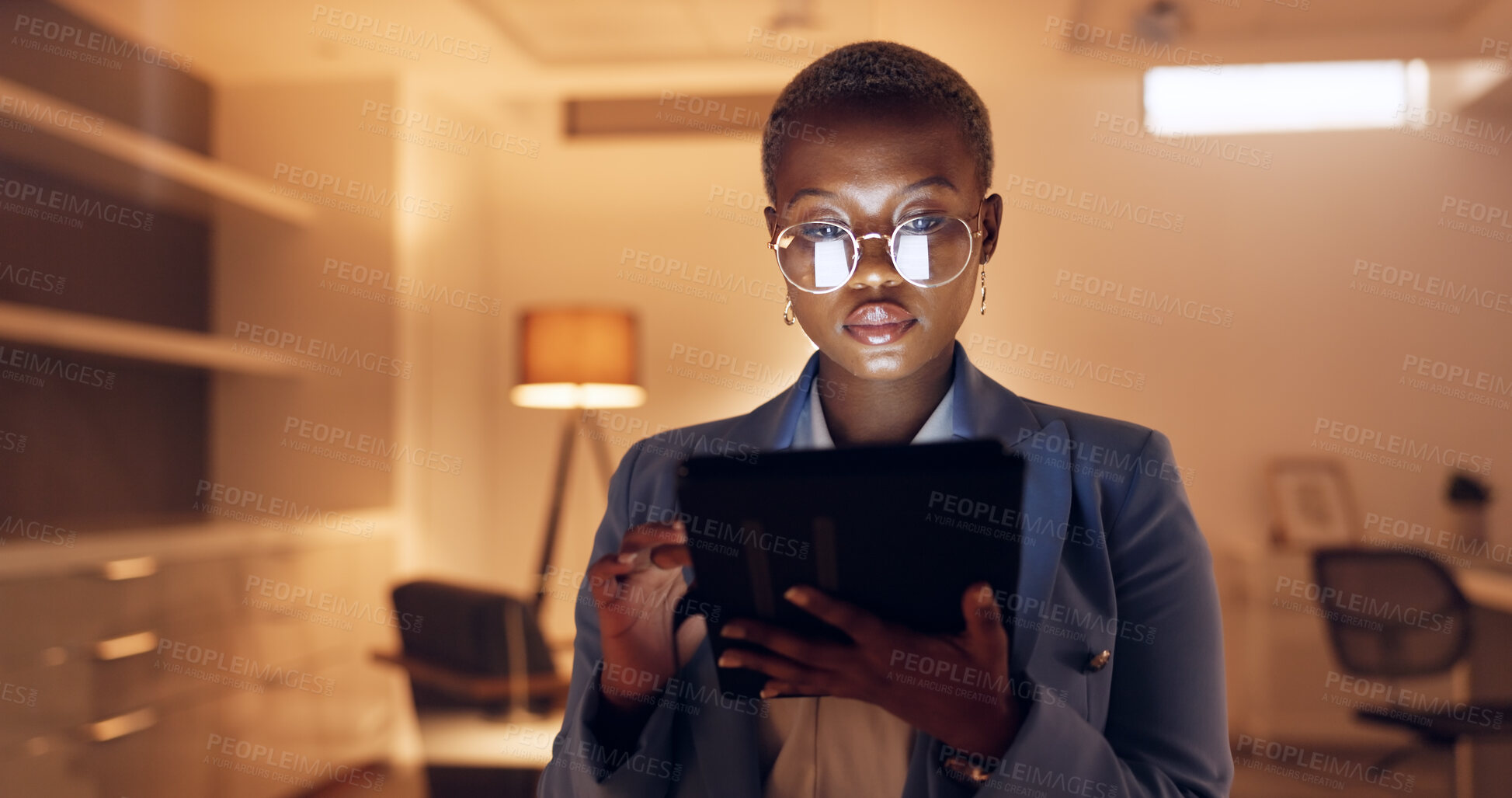 Buy stock photo Black woman, tablet and night at business office working on digital design project or online research. Social media, internet scroll and employee with company website layout on tech of web designer