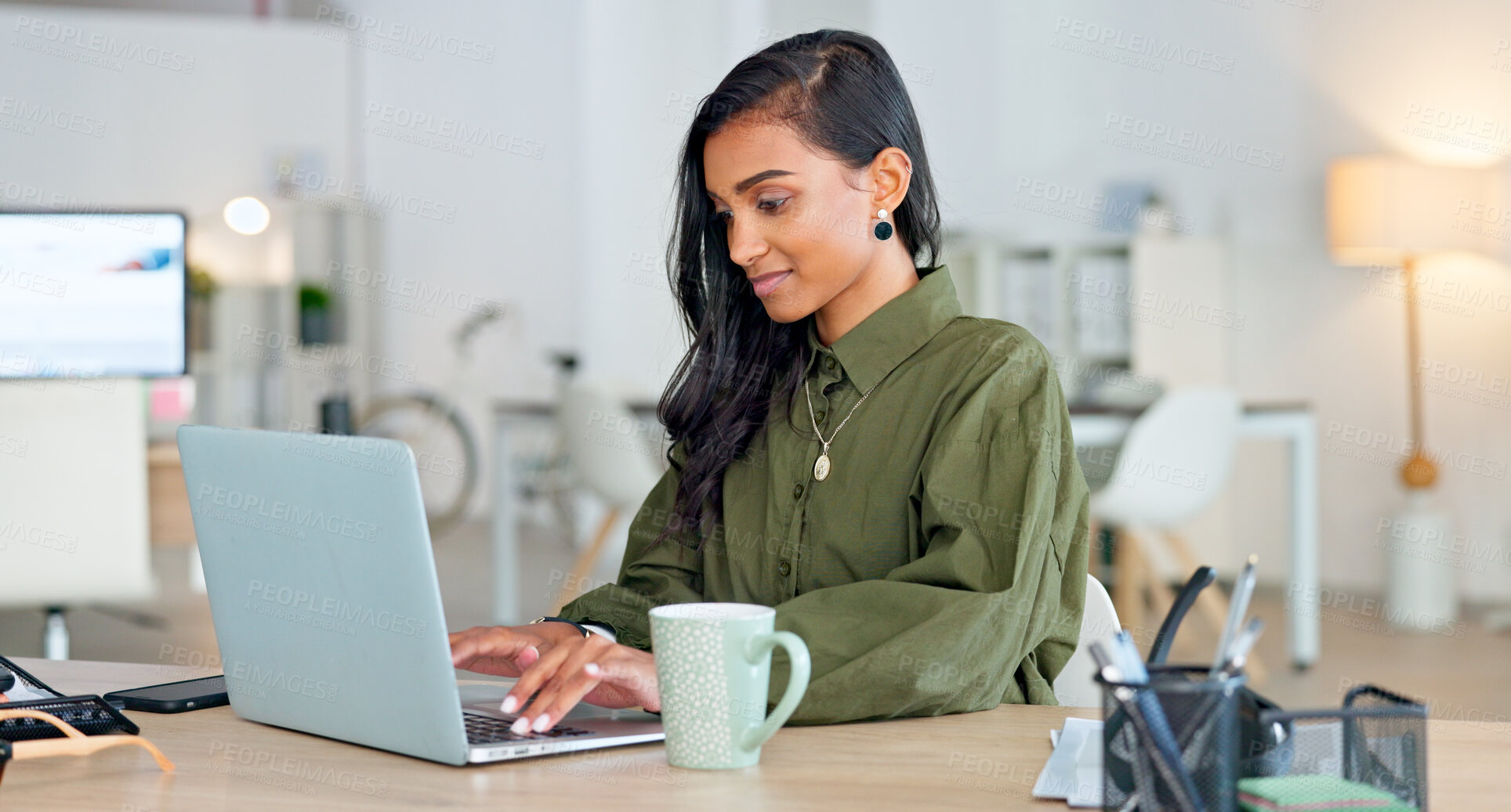 Buy stock photo Happy, business woman and typing on laptop in office with pride, confidence and planning proposal, report or email. Indian, entrepreneur and working on a project with a smile in corporate workplace