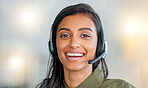 Happy, friendly and confident face of a call center agent smiling in her office with copy space. Portrait of a female customer service employee wearing a headset with copyspace at her workplace