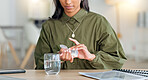 Young woman taking medical drugs at home with a glass of water. Lady takes out the right amount of pills for her medication that was prescribed. Careful female giving herself treatment for relief.