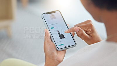 Shopping online and scrolling through makeup products to find a sale or discount. Hands of a woman browsing cosmetics on her phone from above. Enjoying the convenience and ease of purchasing apps