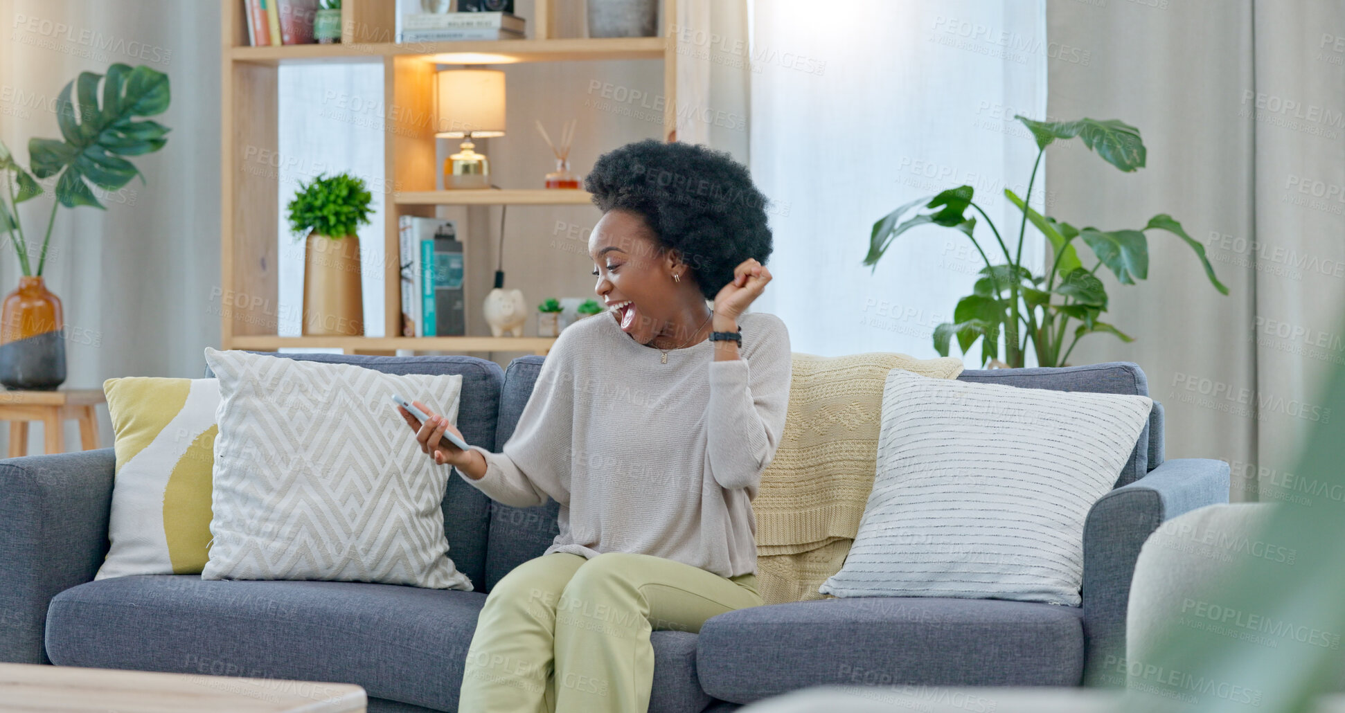 Buy stock photo Black woman, phone and celebration on sofa for lottery, promotion or winning prize in living room at home. Excited African female person smile with afro in success, victory or good news at house