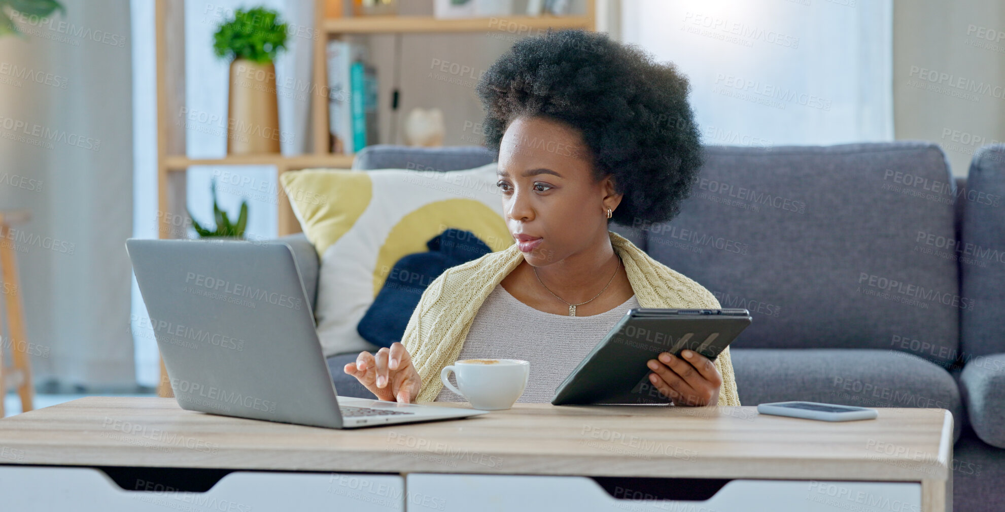 Buy stock photo Black woman, tablet and laptop in remote work, research or online communication in living room at home. African female person or freelancer with afro working on technology for networking at house