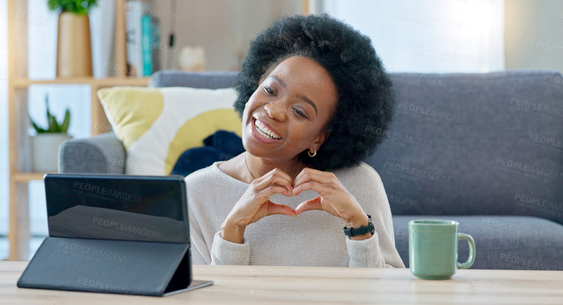 Buy stock photo Woman, tablet and heart sign in video call, smile and hello for contact, icon or emoji on floor in house. African influencer girl, digital touchscreen and happy with love symbol for live streaming