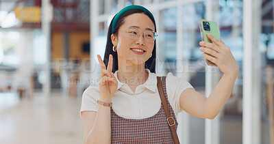 Buy stock photo Selfie, smile and Asian businesswoman in the airport for social media, mobile app or the internet. Happy, peace sign and professional female designer taking a picture for a company trip in a hotel.