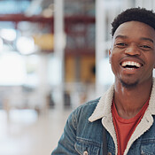 Black man, face and smile portrait in building for designer success ...