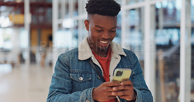 Creative black man, phone and smile for texting, communication or social media at the office. Happy African American man enjoying online conversation, discussion or chat on smartphone for startup