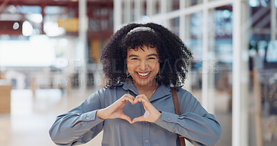 Hands, heart and love with a business black woman making a hand gesture alone in her office at work. Happy, smile and positive with a female employee gesturing a hand sign for romance or affection