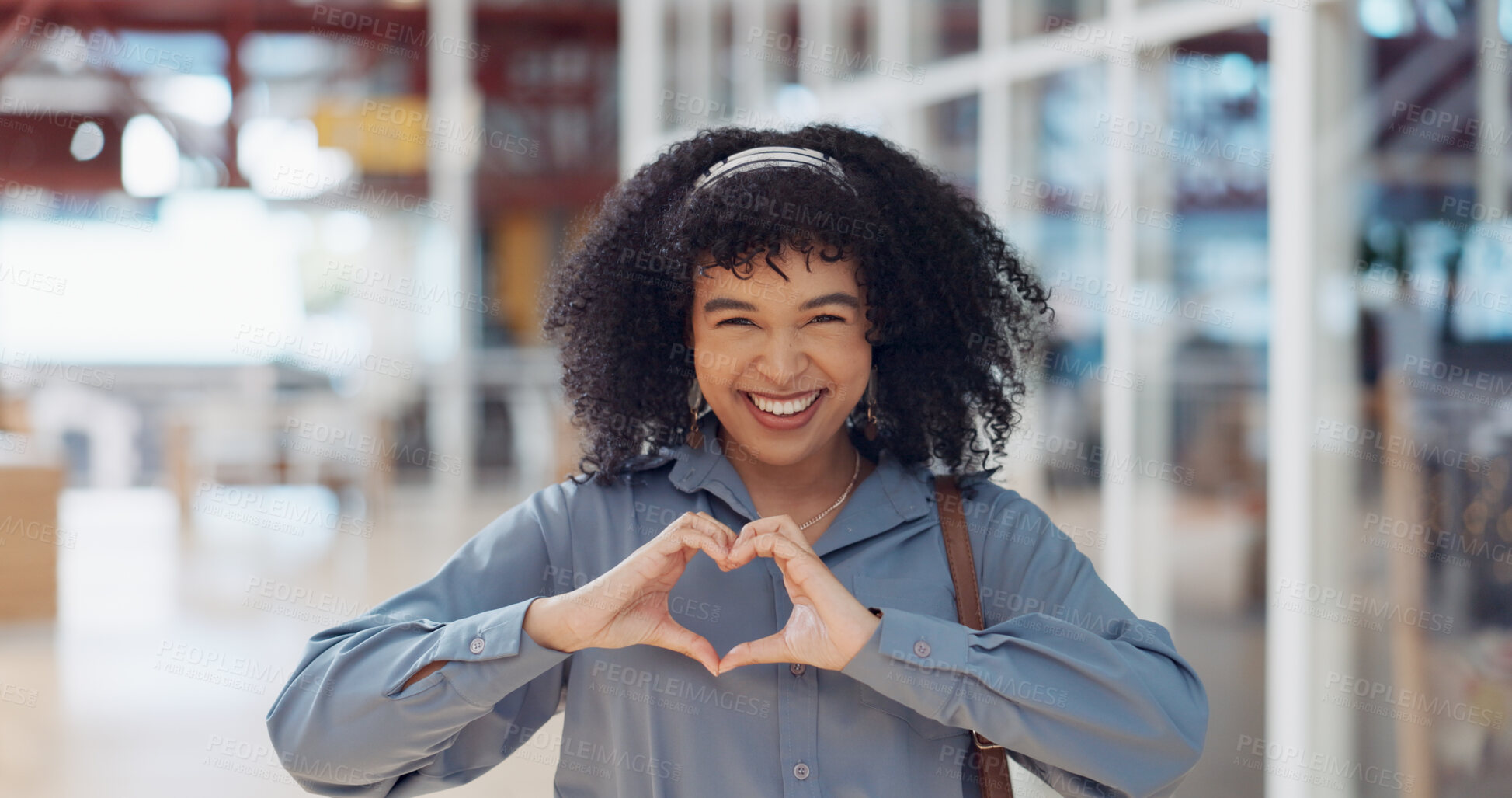 Buy stock photo Hands, heart and love with a business black woman making a hand gesture alone in her office at work. Happy, smile and positive with a female employee gesturing a hand sign for romance or affection