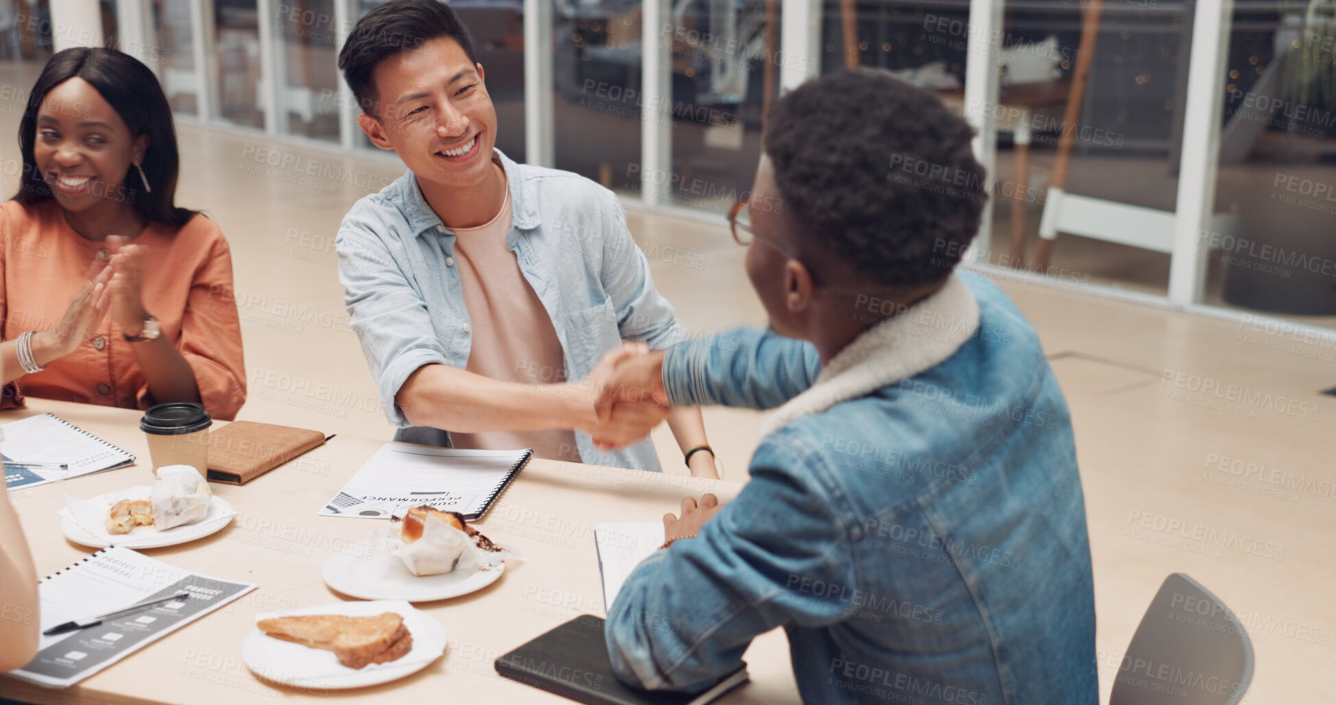 Buy stock photo Meeting, shaking hands at workshop and business people at startup office with agreement, diversity and smile. Onboarding, support and deal handshake, men and women together in success at lunch table.