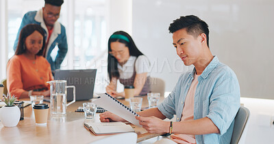 Buy stock photo Meeting, document and Asian man in the office reading for discussion with team of business people. Paperwork, creative and professional young male designer with paperwork in workplace boardroom.