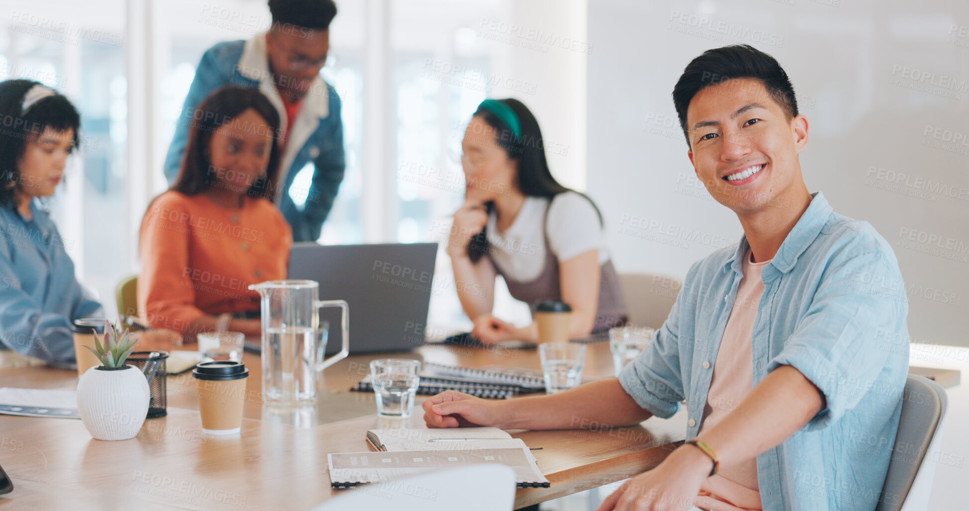 Buy stock photo Portrait, asian business man and meeting with team for collaboration, brainstorming development or project management workshop. Happy young employee working with staff in boardroom of creative agency