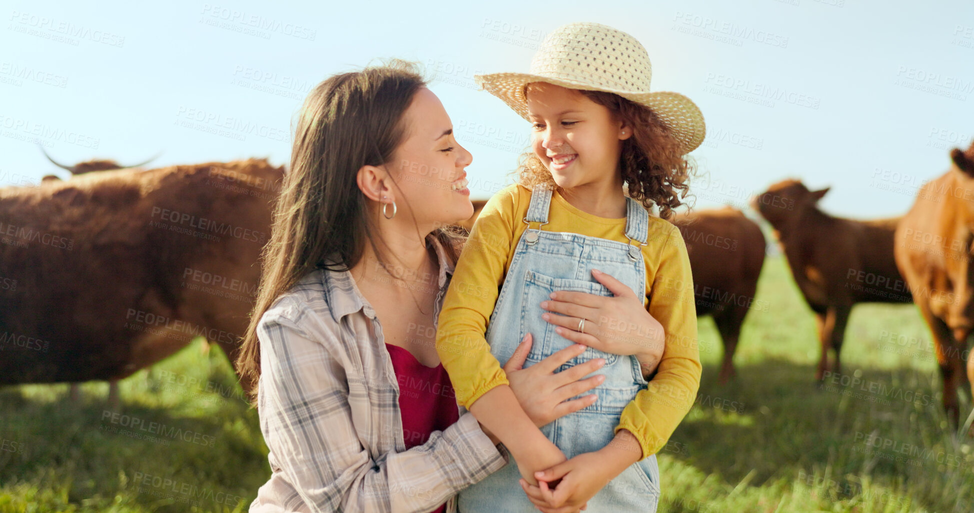 Buy stock photo Farm, smile and mother hugging her daughter with cattle for agriculture in a field for sustainability. Countryside, family and a happy farmer woman embracing her girl child outdoor for dairy farming