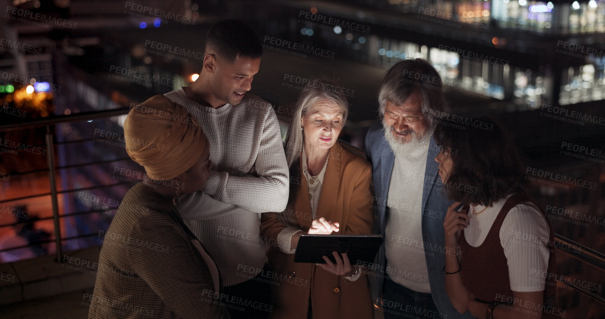 Buy stock photo Tablet, night and teamwork with business peaople on the balcony of their office together for planning. Technology, collaboration and overtime training with an employee team in the city for late work