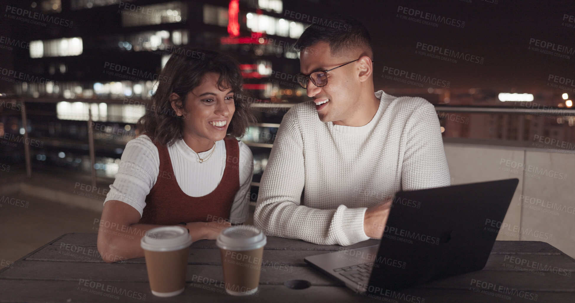 Buy stock photo Business, people and coffee break at night for work, collaboration and reading laptop together on balcony in the city. Teamwork, project and employees working overtime on development for deadline