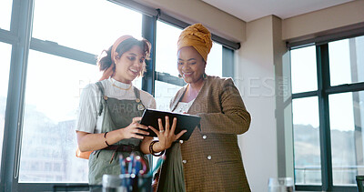 Digital tablet, women and marketing team doing creative research for a project in their office. Collaboration, teamwork and female business partners checking their company website on a mobile device.