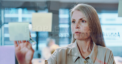 Buy stock photo Brainstorming, note and woman writing or planning on glass, wall or storyboard in creative London business meeting or presentation. Office, strategy and employee thinking of ideas with inspiration