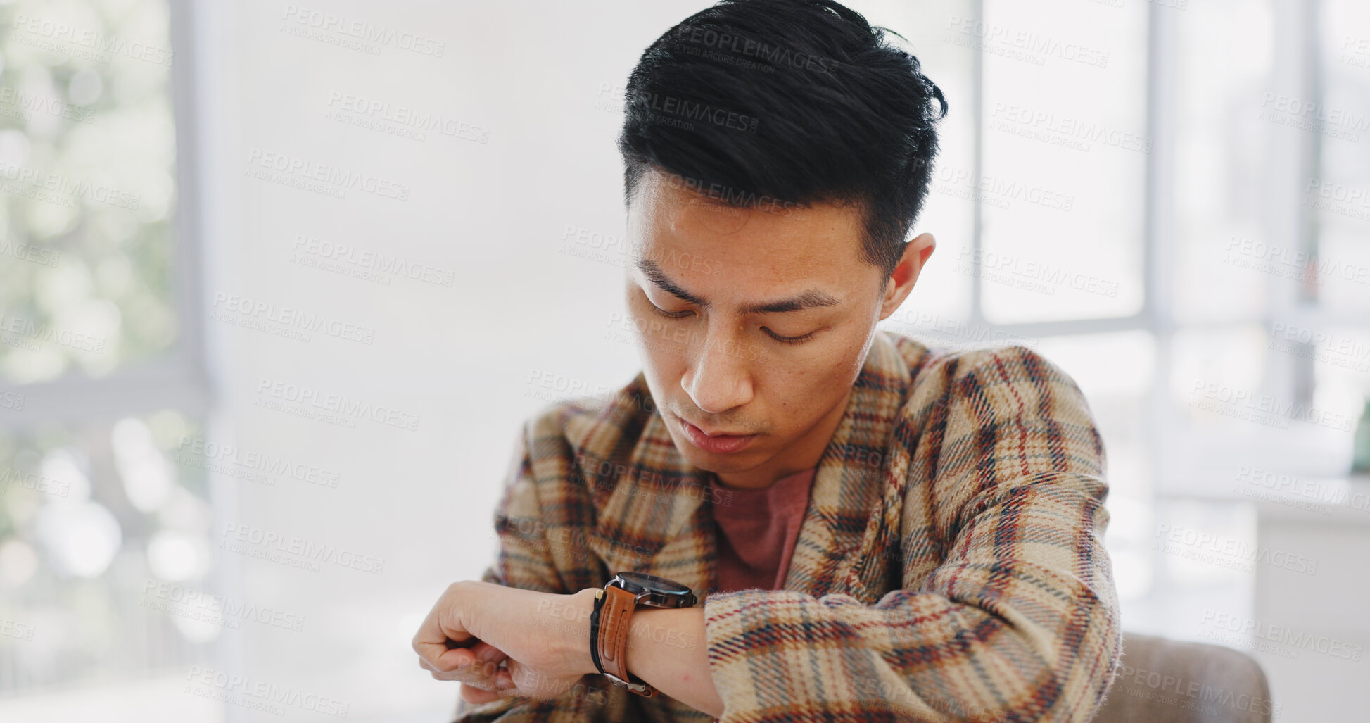 Buy stock photo Schedule, watch and Asian man in interview waiting room for recruitment and check time in a company office. Deadline, worried and employee with wristwatch alarm ready for meeting appointment