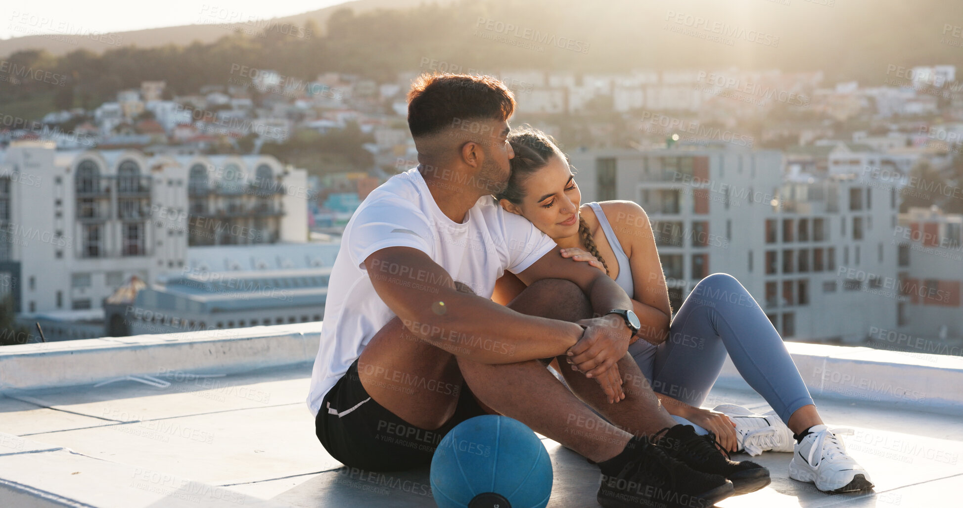 Buy stock photo Happy couple, fitness and relax on rooftop break after workout, training or outdoor exercise together in city. Man and woman hug on balcony in rest from cardio, sports or practice in an urban town