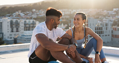 Buy stock photo Couple, fitness and city to rest and talk for exercise, workout or training together on rooftop. Happy man and woman on sports break with a laugh, communication or conversation about wellness