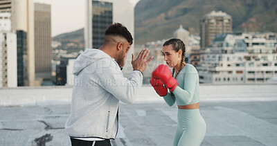 Fitness, couple and boxing or training in the city for exercise, sport or workout in the outdoors. Woman boxer and personal trainer man or coach in sports practice for fighting, cardio or endurance