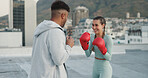 Woman, boxing and coach training, sport and fitness outside with punch, glove and outdoor in a city. Female athlete or boxer practice, workout and exercise for fight, match or cardio with motivation