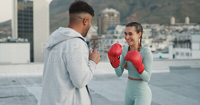Woman, boxing and coach training, sport and fitness outside with punch, glove and outdoor in a city. Female athlete or boxer practice, workout and exercise for fight, match or cardio with motivation