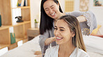 Friends, brush hair and women in bedroom get ready for bed, girls night out or special event. Happy, smile and girlfriends grooming at sleepover at home. Asian girl and friend talk in pajamas on bed.