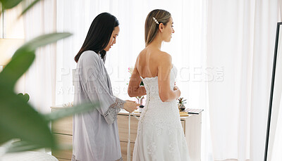 Happy bride in wedding dress, friends helping with knot on luxury corset back string and young women together in home. Asian woman supporting hug, marriage ready preparation and bridesmaid happiness