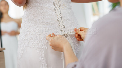 Friends helping woman with wedding dress knot in a room or boutique for marriage ready, fitting or fashion with corset lace detail and hands. Bride with mirror reflection getting ready for love event