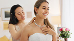 Wedding, friends and bride with necklace jewelry for beauty, wealth and luxury with happiness and fashion lifestyle. Happy women and bridesmaid in dressing room helping with silver diamond chain