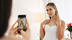 Wedding, ring and engagement with a woman or bride taking a photograph on a phone and drinking champagne with a friend. Happy, smile and celebration with an attractive young female and her bridesmaid